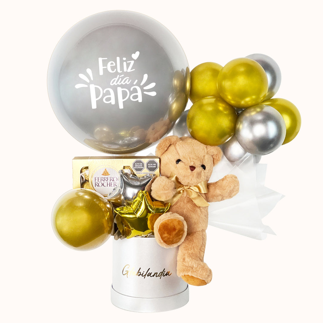 Gift box en colores dorado y negro, ideal para regalar a papá en su día o cualquier ocasión especial, que incluye 1 peluche de osito mediano, 1 globo burbuja personalizable, 1 caja de Ferrero Rocher (8 unidades), globitos decorativos y caja de regalo deluxe satinada, perfecto para sorprender con un detalle especial.