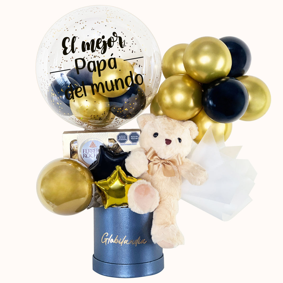Gift box en colores dorado y negro, ideal para regalar a papá en cualquier ocasión especial, que incluye 1 peluche de osito mediano, 1 globo burbuja personalizable, 1 caja de Ferrero Rocher (8 unidades), globitos decorativos y caja de regalo deluxe satinada, perfecto para sorprender con un detalle especial.