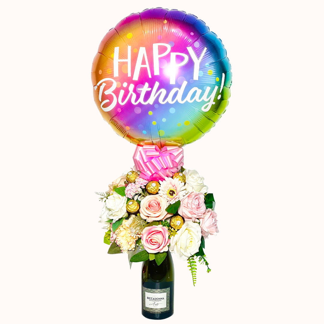 Botella Riccadonna Asti 750 ml decorada con: 1 globo happy birthday,, 5 unidades chocolate ferrero rocher y flores artificiales decorativas. ideal para regalo de cumpleaños.