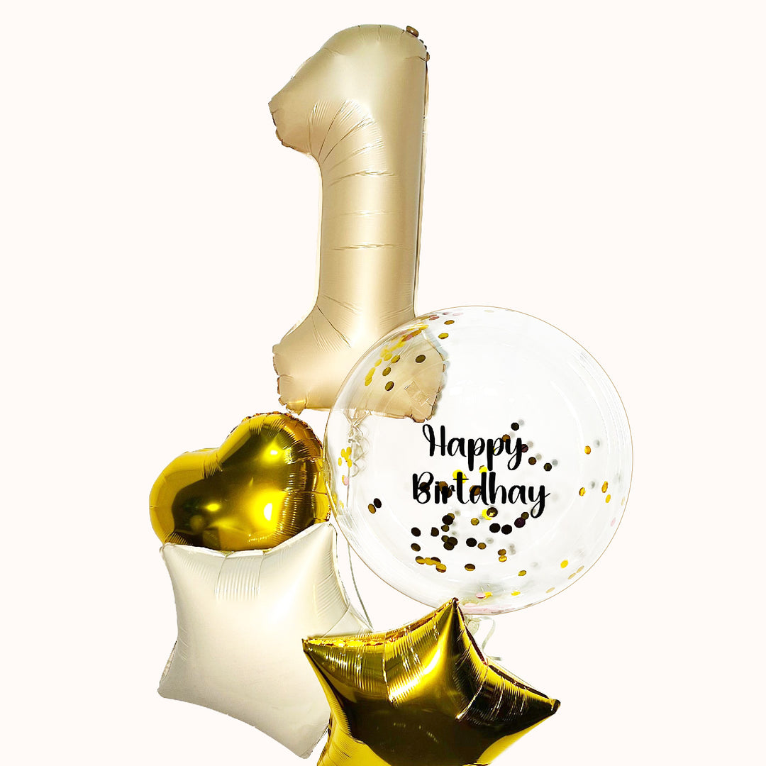 Ramo de 5 globos inflados con helio: 1 globo número en color beige, 1 globo burbuja transparente con confeti y 3 globos metálicos. Ideal para celebrar cumpleaños y aniversarios.