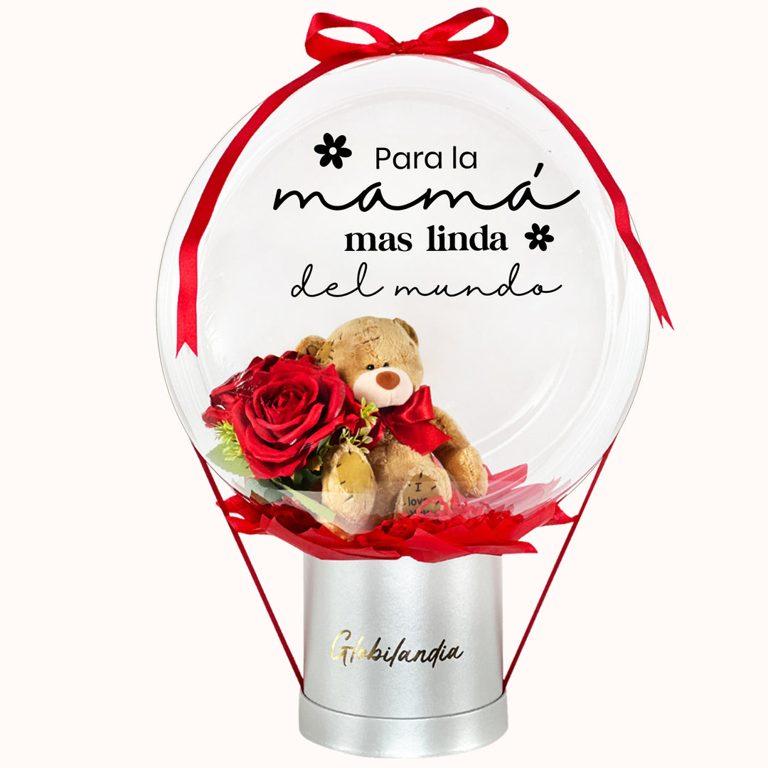 Gift box deluxe con globo burbuja y osito de peluche con flores en su interior, opción de personalizar con nombre. Ideal para sorprender a mamá en su día.