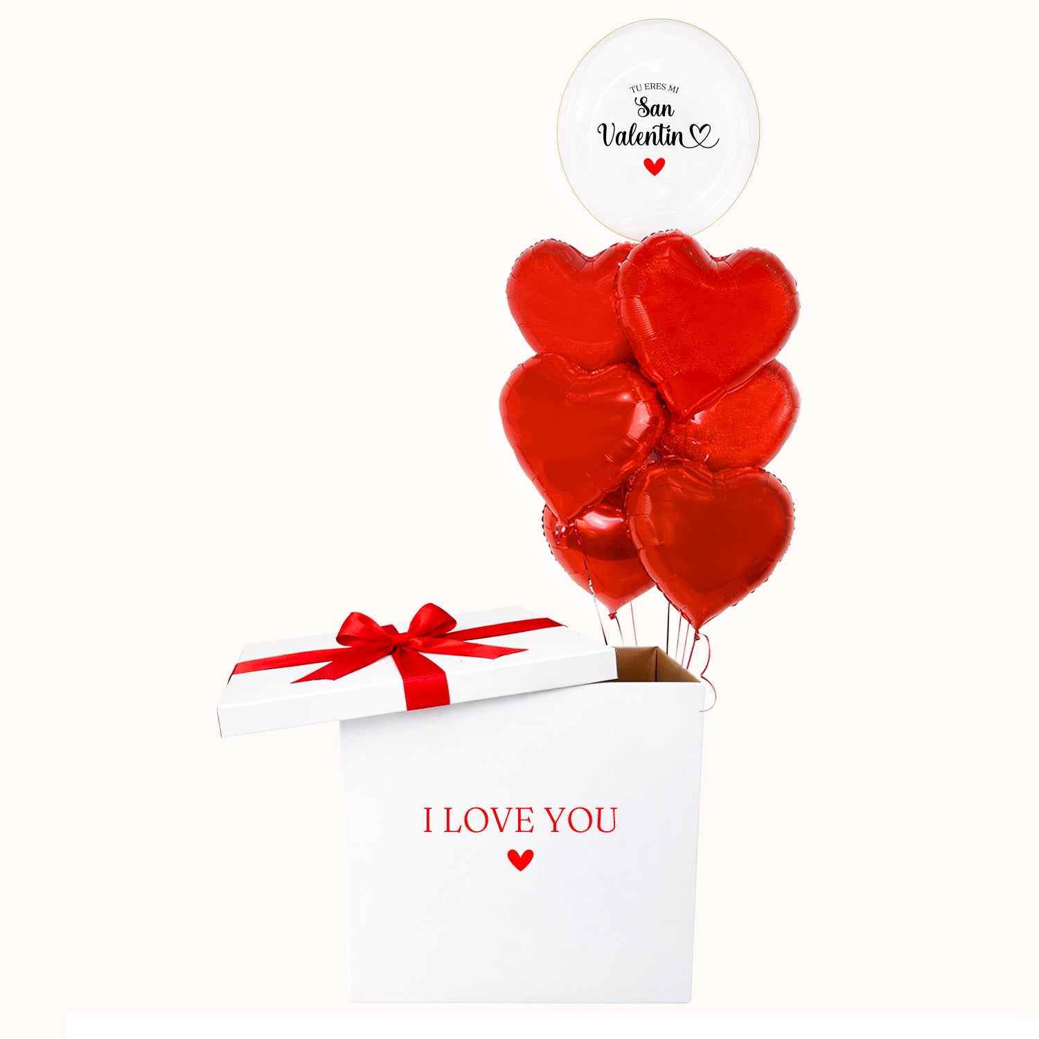 Caja sorpresa de cartón blanca, decorada con lazo y personalizada con la frase “I Love You”, que incluye un bouquet con 1 globo burbuja y 6 globos metálicos en forma de corazón, inflados con helio. Un detalle para celebrar el Día de San Valentín o cualquier ocasión especial