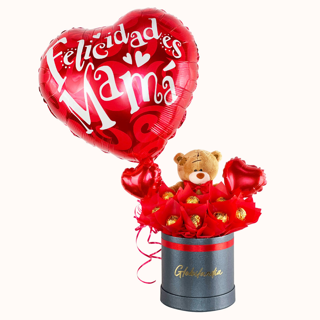 Gift box para el Día de la Madre con globo metálico alusivo, peluche de oso pequeño, 8 bombones de avellana, globitos decorativos pequeños y caja de regalo satinada. Ideal para sorprender a mamá en su día.