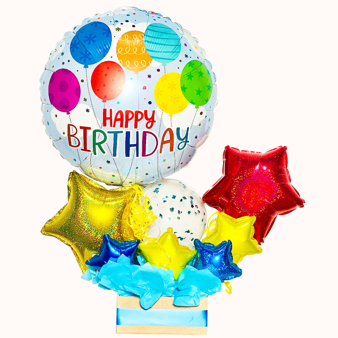 Regalo de cumpleaños que incluye 1 globo metálico “Happy Birthday”, 1 globo burbuja confetti, globos decorativos en forma de estrella y caja de trupan pequeña, ideal para sorprender en una celebración especial.