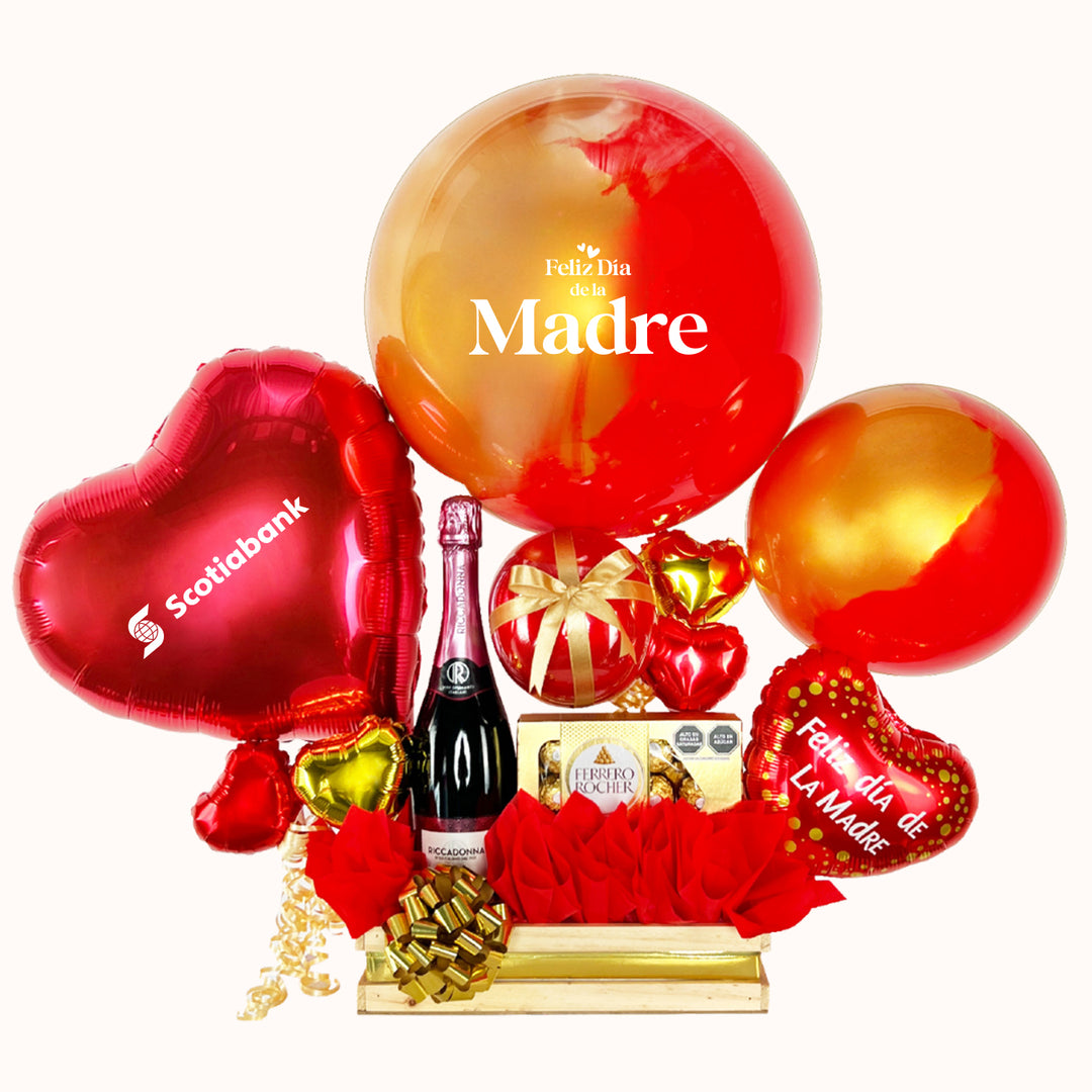 Gift box corporativo para campaña del Día de la Madre que incluye globo burbuja pintado y personalizado, globo corazón con logo, globos burbuja pequeños decorativos, botella de Riccadonna Ruby 750 ml, caja de Ferrero Rocher (8 unidades), globitos decorativos pequeños y caja de regalo grande, ideal para obsequios empresariales en esta fecha especial.