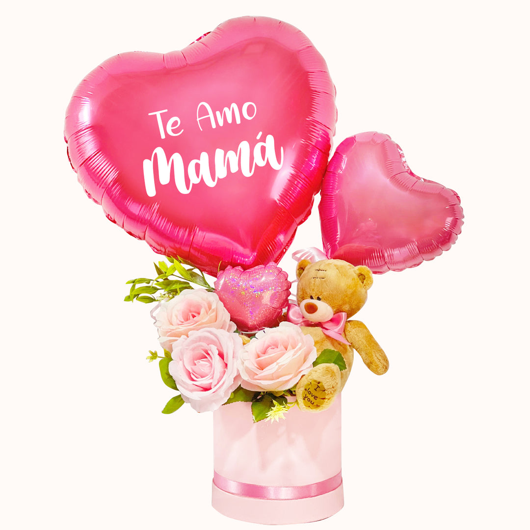 Arreglo para el Día de la Madre con rosas decorativas artificiales, peluche de osito mediano y globo de corazón personalizable. Ideal para sorprender a mamá en su día.
