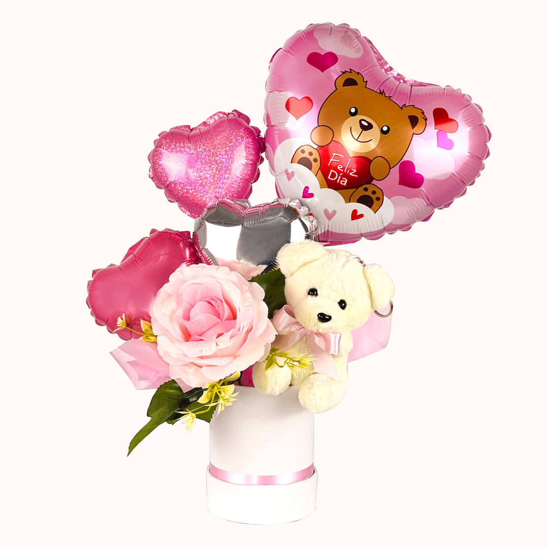 Detalle para regalar en el Día de la Mujer: mini gift box en base circular, con osito de peluche y globitos en tonos Rosado con mensaje feliz día.