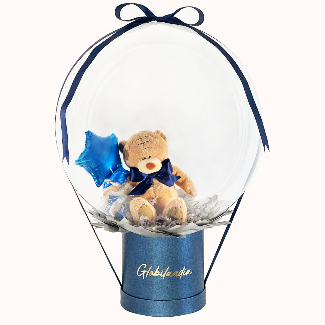 Gift box con osito encapsulado, globo burbuja, chocolates y globito estrella; un regalo especial para sorprender a hombres con un detalle único y lleno de cariño en cualquier ocasión.