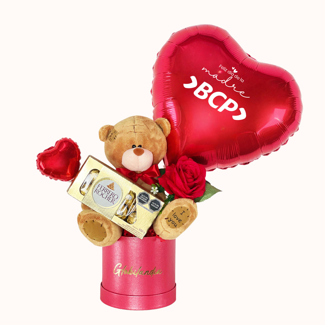 Gift box corporativo para campaña del Día de la Madre que incluye 1 globo metálico con logo, 1 peluche de oso mediano, 1 caja de Ferrero Rocher (8 unidades), rosa artificial decorativa, globitos decorativos pequeños y caja de regalo satinada, ideal para obsequiar a clientas y colaboradoras.