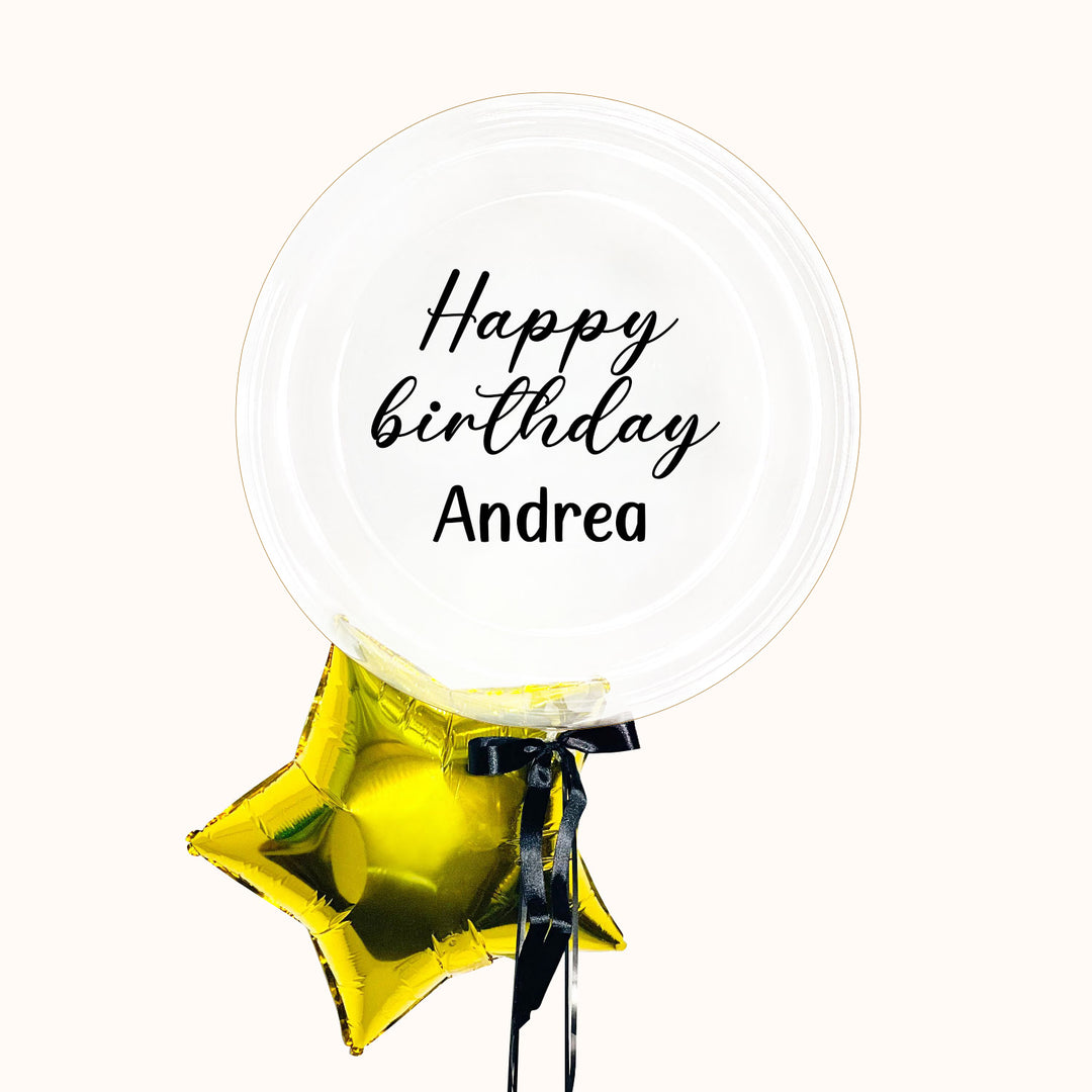 Bouquet de 2 globos con helio: 1 globo burbuja transparente personalizado y 1 globo estrella metálica dorada. Colores a elegir. Ideal para regalar en cumpleaños o cualquier ocasión especial.