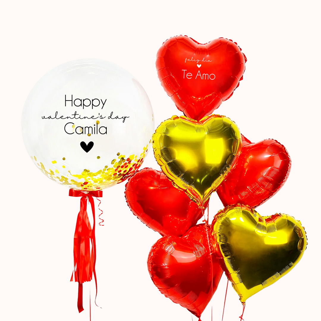 Bouquet con globo burbuja transparente relleno de confetti, decorado con un lazo y flequillo rojo, acompañado de 6 globos metálicos en forma de corazon.  Para celebrar el Día de San Valentín o aniversario de pareja. Regalo romántico. Inflado con helio 100%