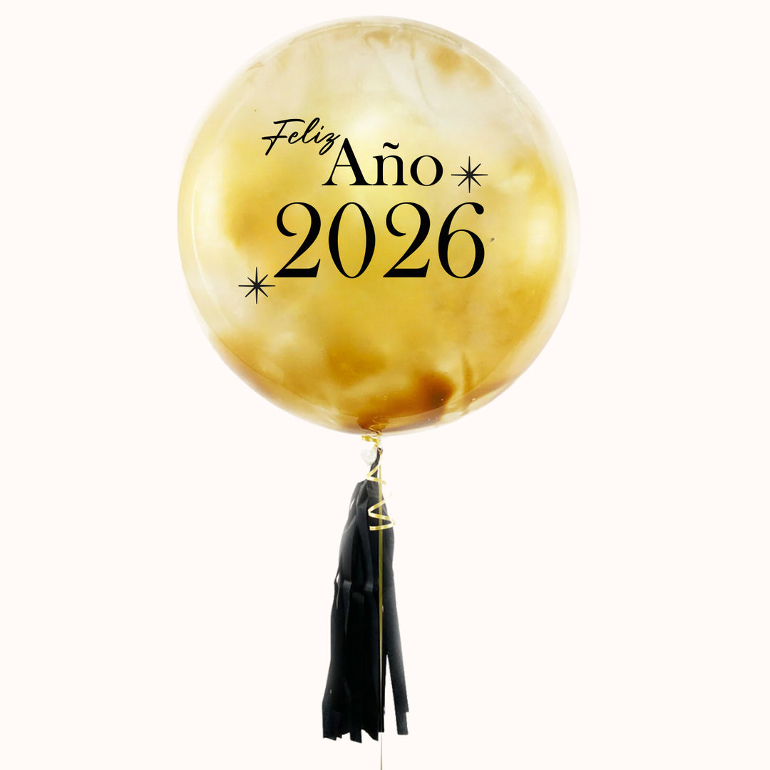 Globo burbuja pintada de color dorado personalizada feliz año, con flequillo negro de papel seda. ideal para festejar año nuevo.