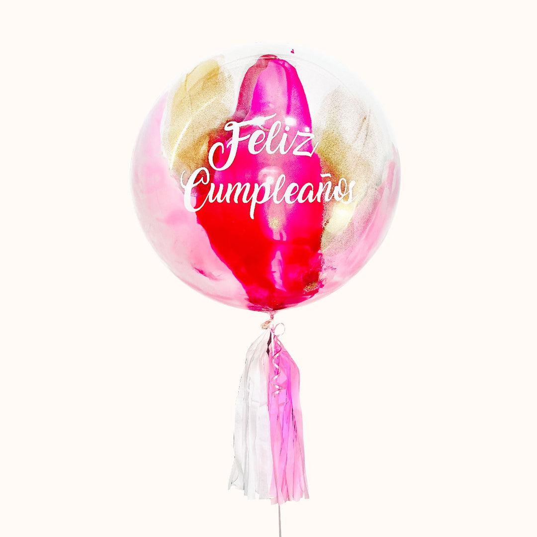 Globo burbuja personalizado, pintado en color dorado, fucsia y dorado  y decorado con flequillo de papel seda en color rosa. Ideal para cumpleaños.