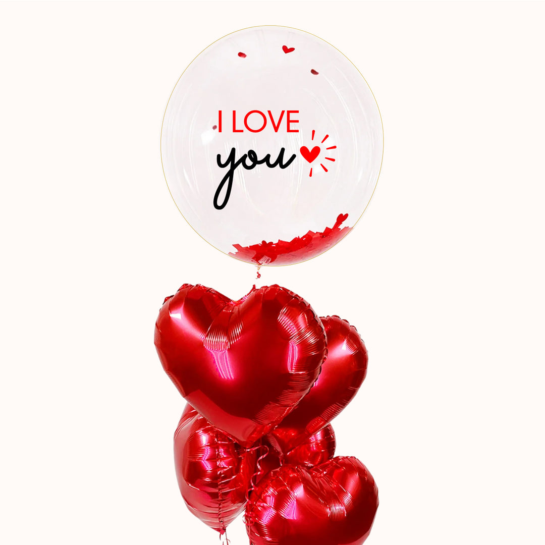 Hermoso bouquet para regalar en San Valentín, que incluye un globo burbuja personalizado y 5 globos metálicos en forma de corazón color rojo. Un detalle inflado con helio y mucho amor, perfecto para enamorar