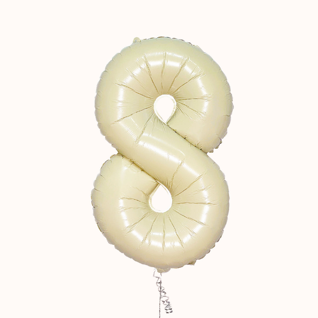Globo metálico de número en color beige/crema, inflado con helio, para cumpleaños o aniversario.