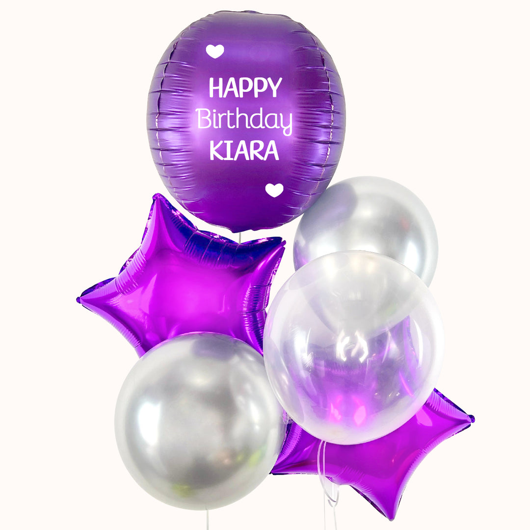 Bouquet de 6 globos con helio en color morado y plata: 1 esfera, 2 globos estrella metálicos, 3 globos látex. Ideal para cumpleaños o cualquier ocasión especial. 
