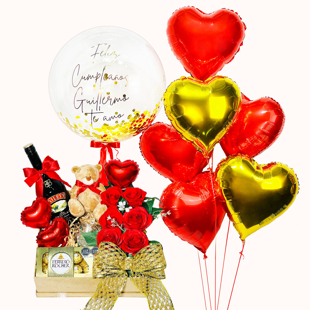 Regalo original para pareja: 1 Globo burbuja personalizado, 6 globos corazón metálicos. Gift Box contiene: 1 peluche osito pequeño, 1 botella de baileys 750 mL, 1 caja ferrero rocher 8 globitos decorativos, flores artificiales. Caja de Regalo pino para San Valentín.