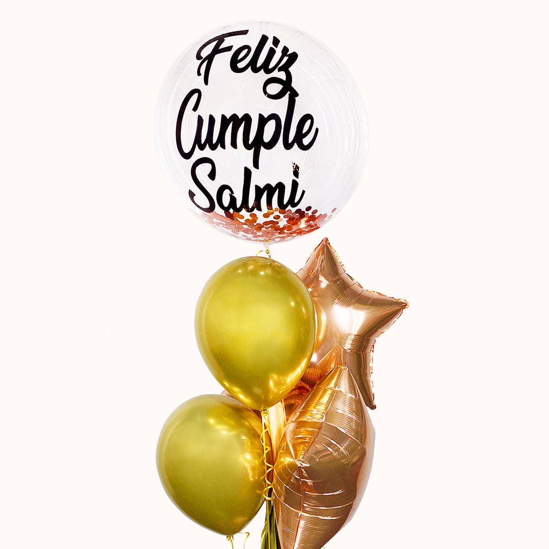 Bouquet de 5 globos con helio: 1 globo burbuja personalizado, 2 globos de látex y 2 globos estrella metálicos. Ideal para celebrar cumpleaños. Disponible en color dorado y rose gold, o en el color de tu elección.