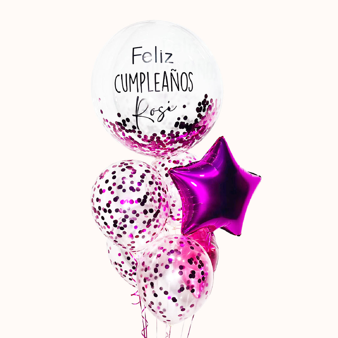 Bouquet de 7 globos con helio: 1 globo burbuja con escarcha personalizado, 4 globos de látex con confeti y 2 globos metálicos en forma de estrella, todo en color fucsia. Ideal para celebrar cumpleaños o cualquier evento especial.