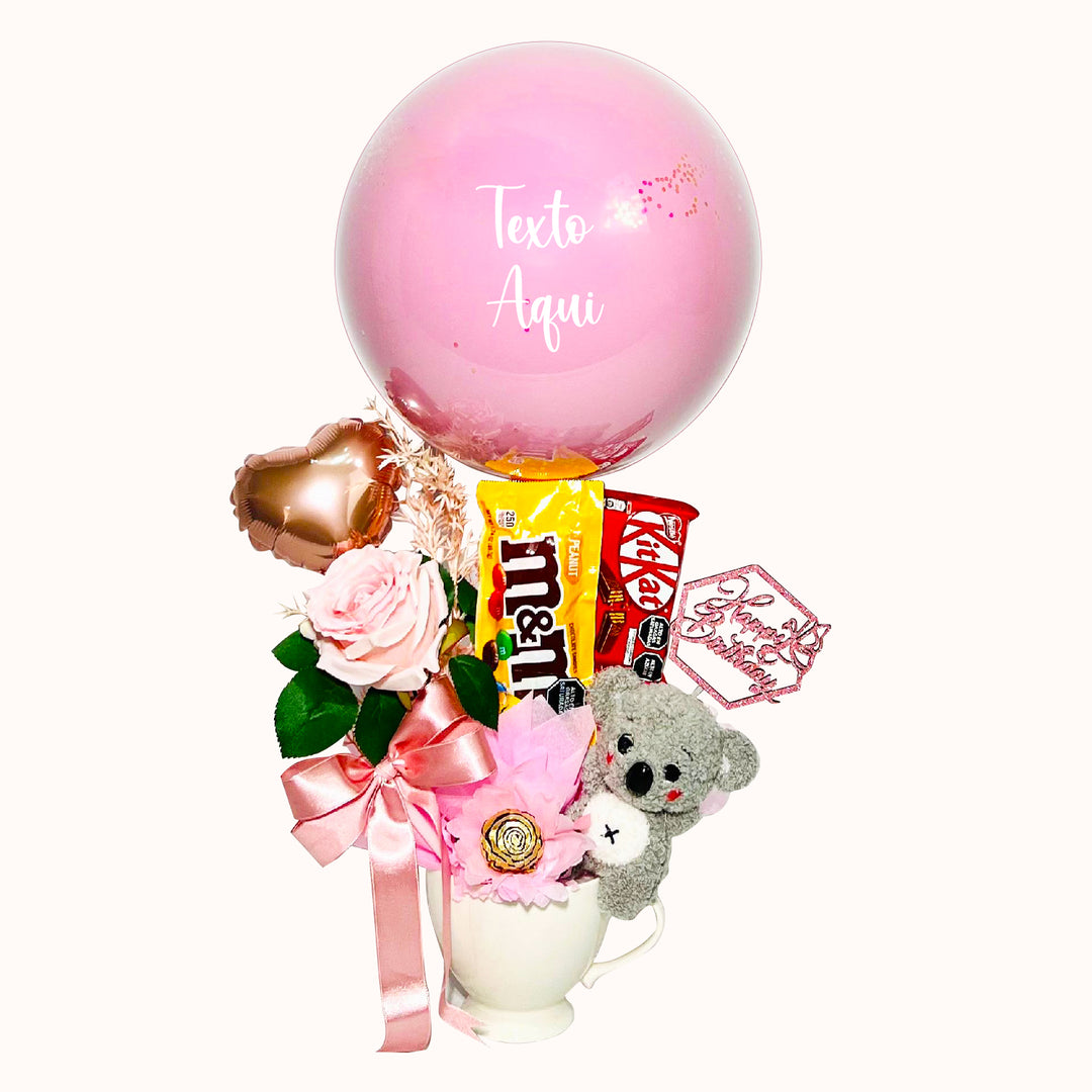 Gift box con taza de cerámica que incluye 1 globo burbuja personalizado con globo de látex en su interior, 1 peluche de animalito, 2 chocolates importados (Kit Kat y M&M), globitos decorativos pequeños y flores decorativas.Especial para cumpleaños.