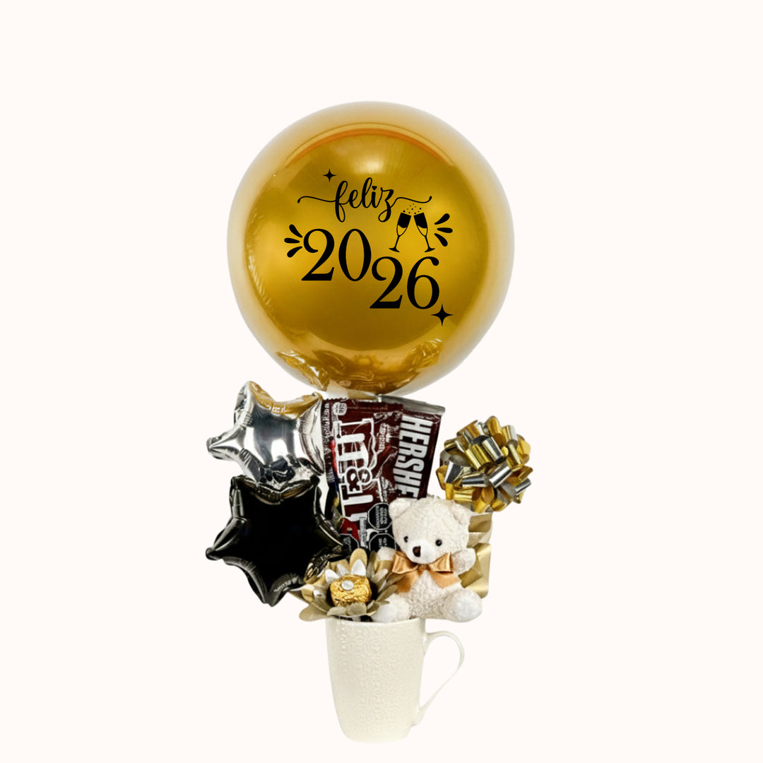 Hermoso gift box que incluye taza, chocolates y globos, personalizado con la frase “Feliz Año”. Un detalle elegante y especial para regalar con estilo y sorprender en las celebraciones de fin de año