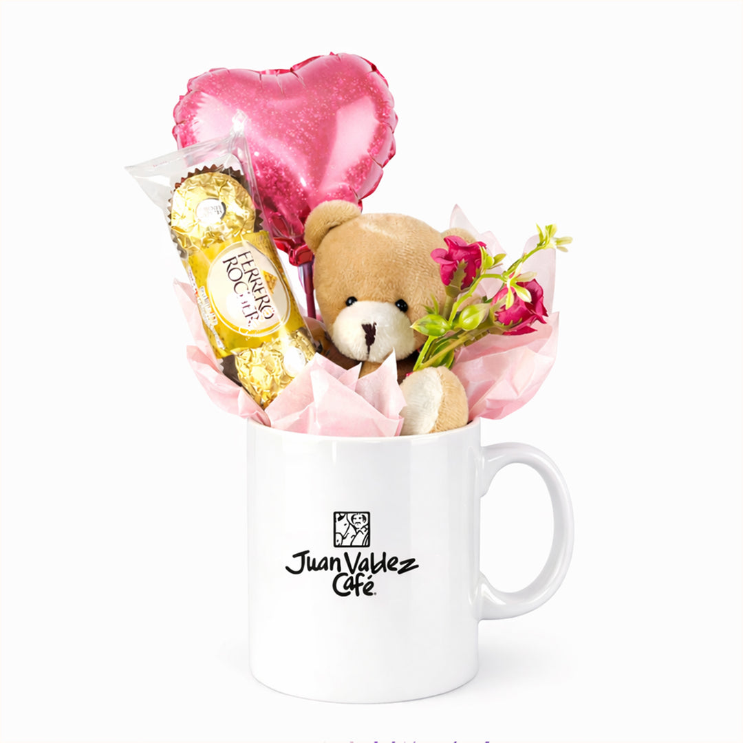 Detalle corporativo para día de la mujer: taza personalizada con tu logotipo empresarial, decorada con chocolates Ferrero Rocher de 3 unidades, 1 osito de peluche y 1 globo de corazón. Regalo a clientes y colaboradores.