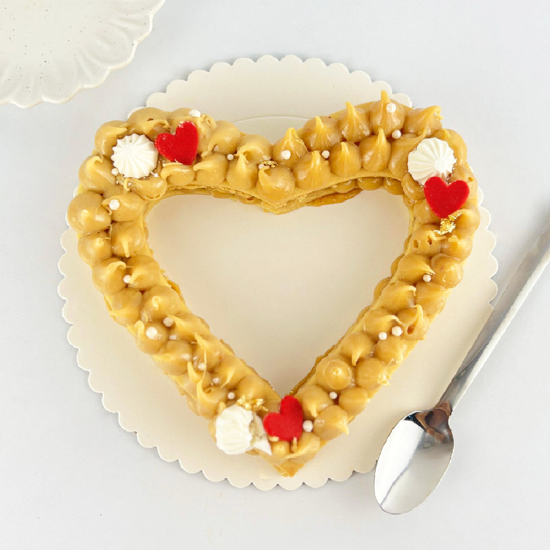 Torta de alfajor en forma de corazón hueco, rellena de delicioso manjar blanco. Medida: 17 cm. Ideal para cumpleaños o cualquier ocasión especial.